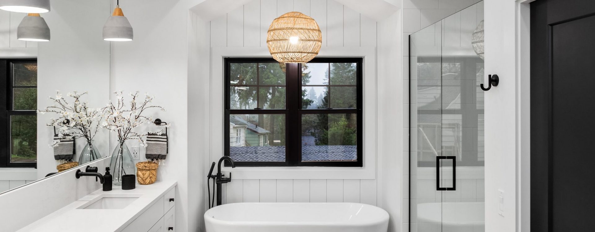 Stylish bathroom with herringbone tile pattern and crisp white decor.