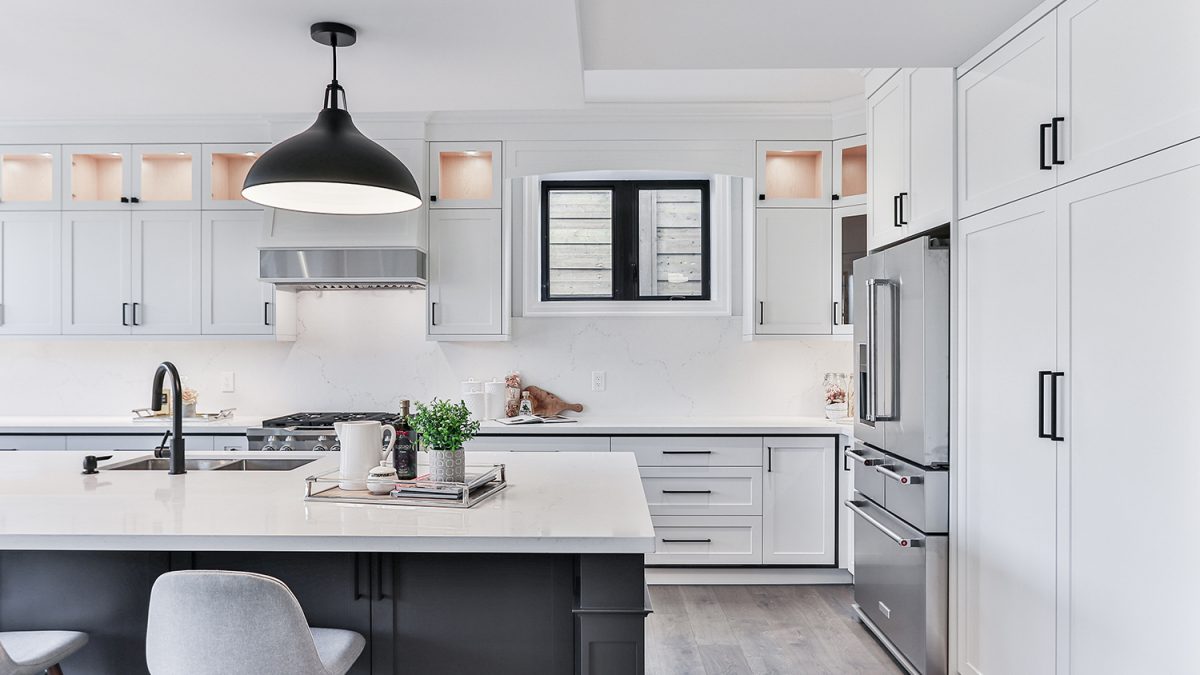 Contemporary kitchen with a sleek island, stainless steel appliances, and a statement pendant light.