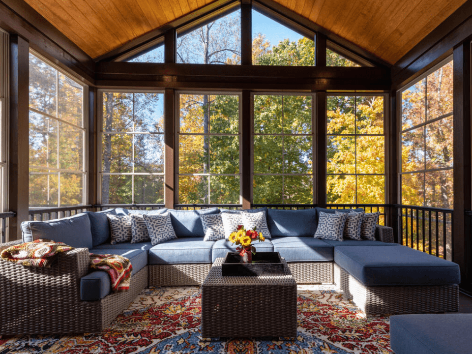 Beautifully decorated fall home windows with colorful leaves and pumpkins.