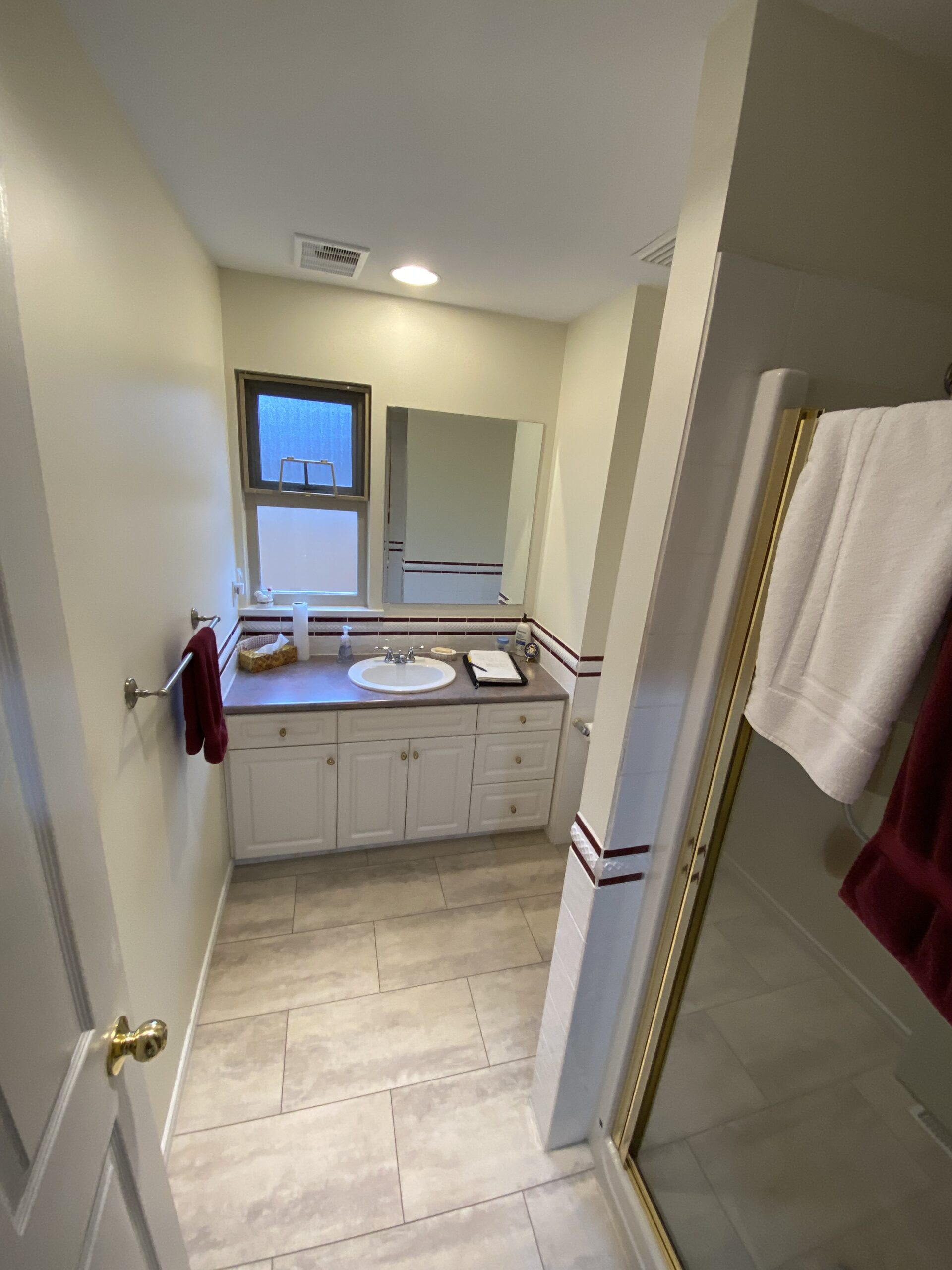 Pre-renovation bathroom with standard fixtures and limited accessibility.