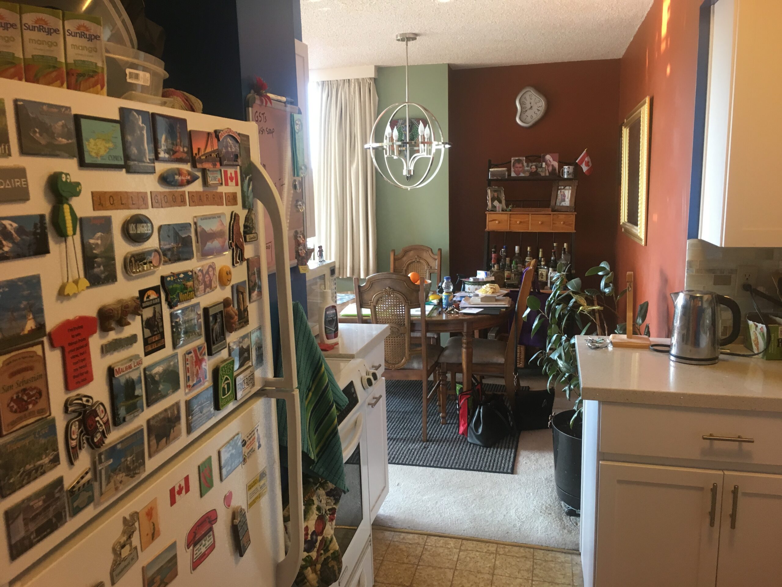 Cluttered kitchen counters and overstuffed fridge before professional organization.