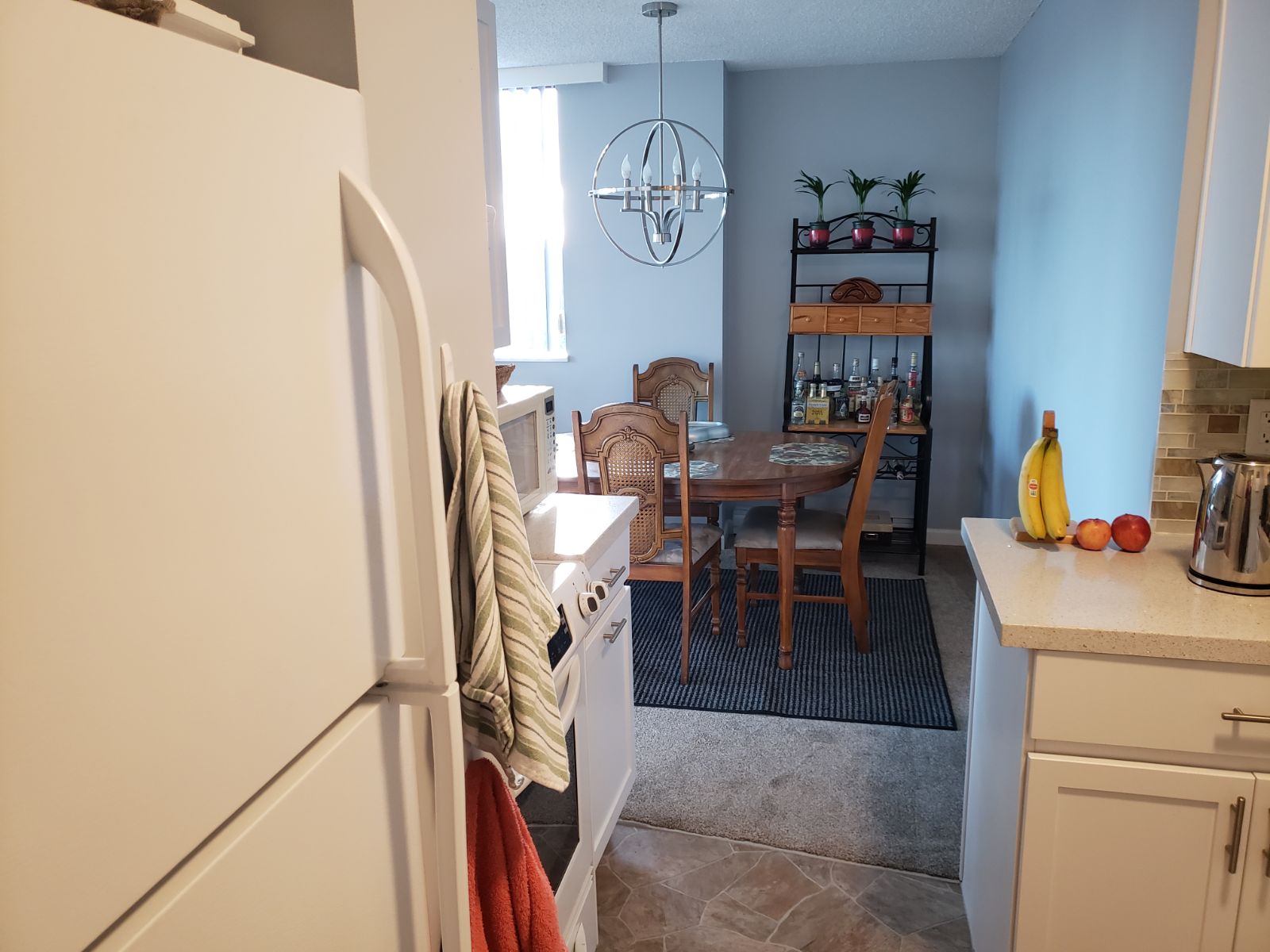 Immaculately organized kitchen with a neat fridge and clear countertops after decluttering.