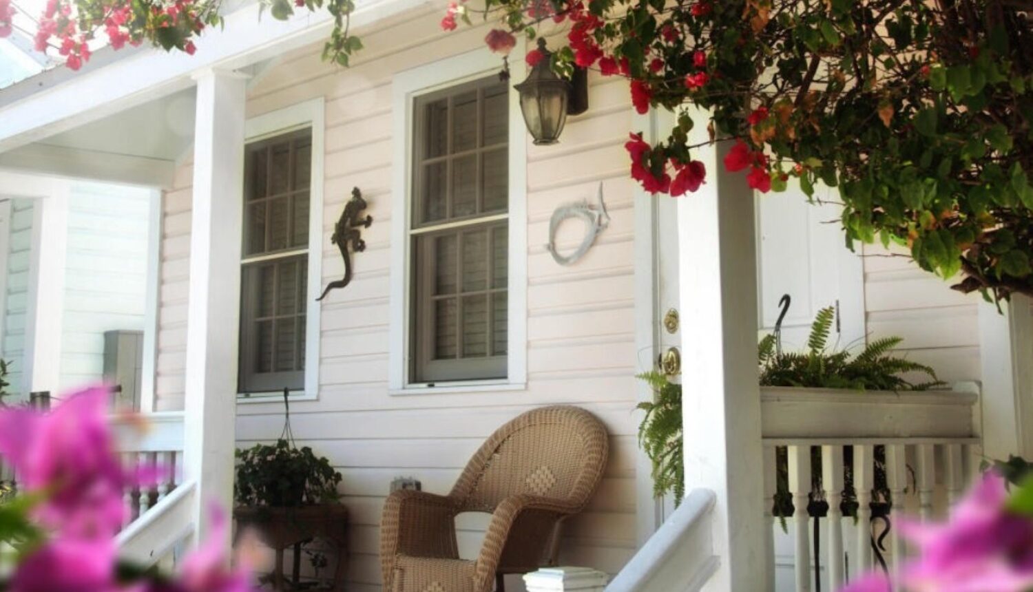 A cozy porch adorned with blooming spring flowers.