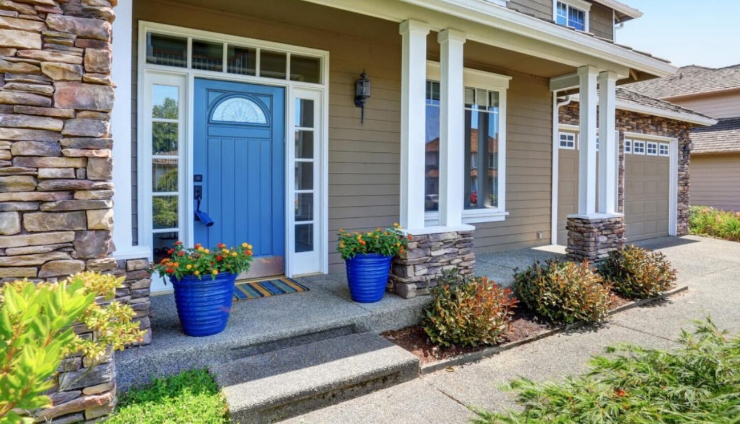 Freshly painted blue front door enhancing the home's spring curb appeal.