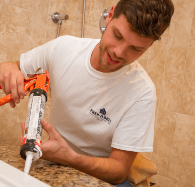 A skilled handyman from Prep'n Sell fixing a sink, showcasing versatile handyman services.