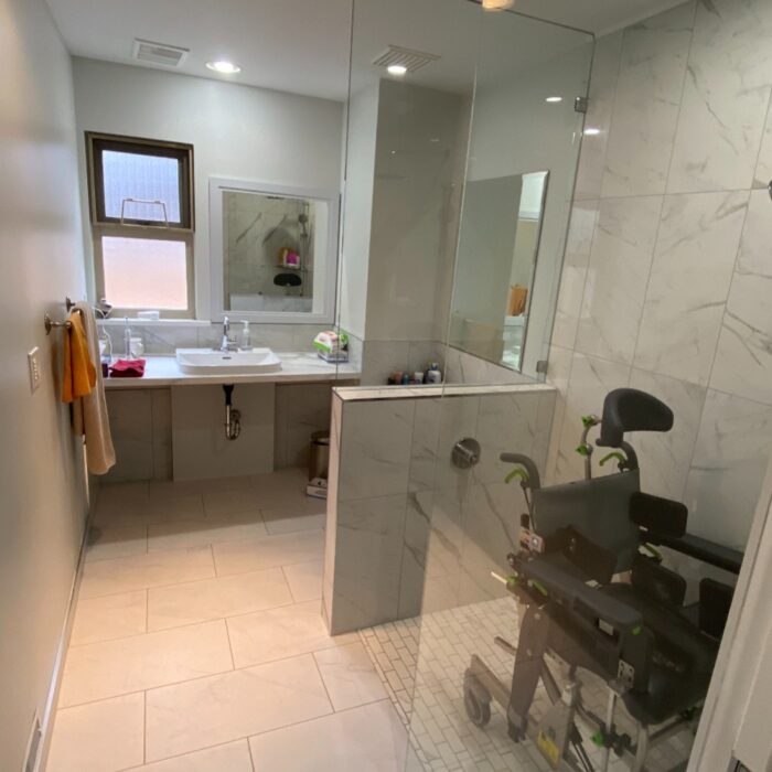 Wheelchair-accessible shower with grab bars and non-slip floor